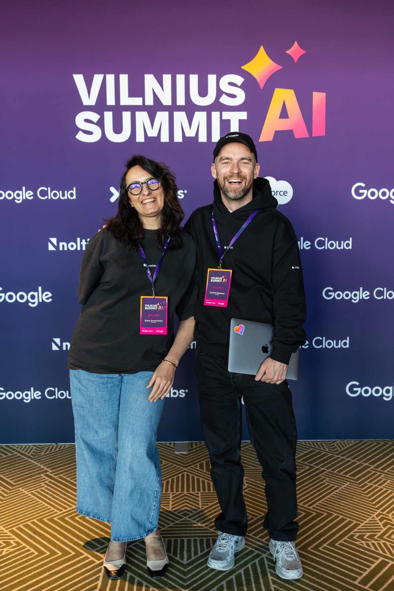 Dima Abramov and Elena Avramenko at Vilnius Summit AI, in front of the event backdrop.