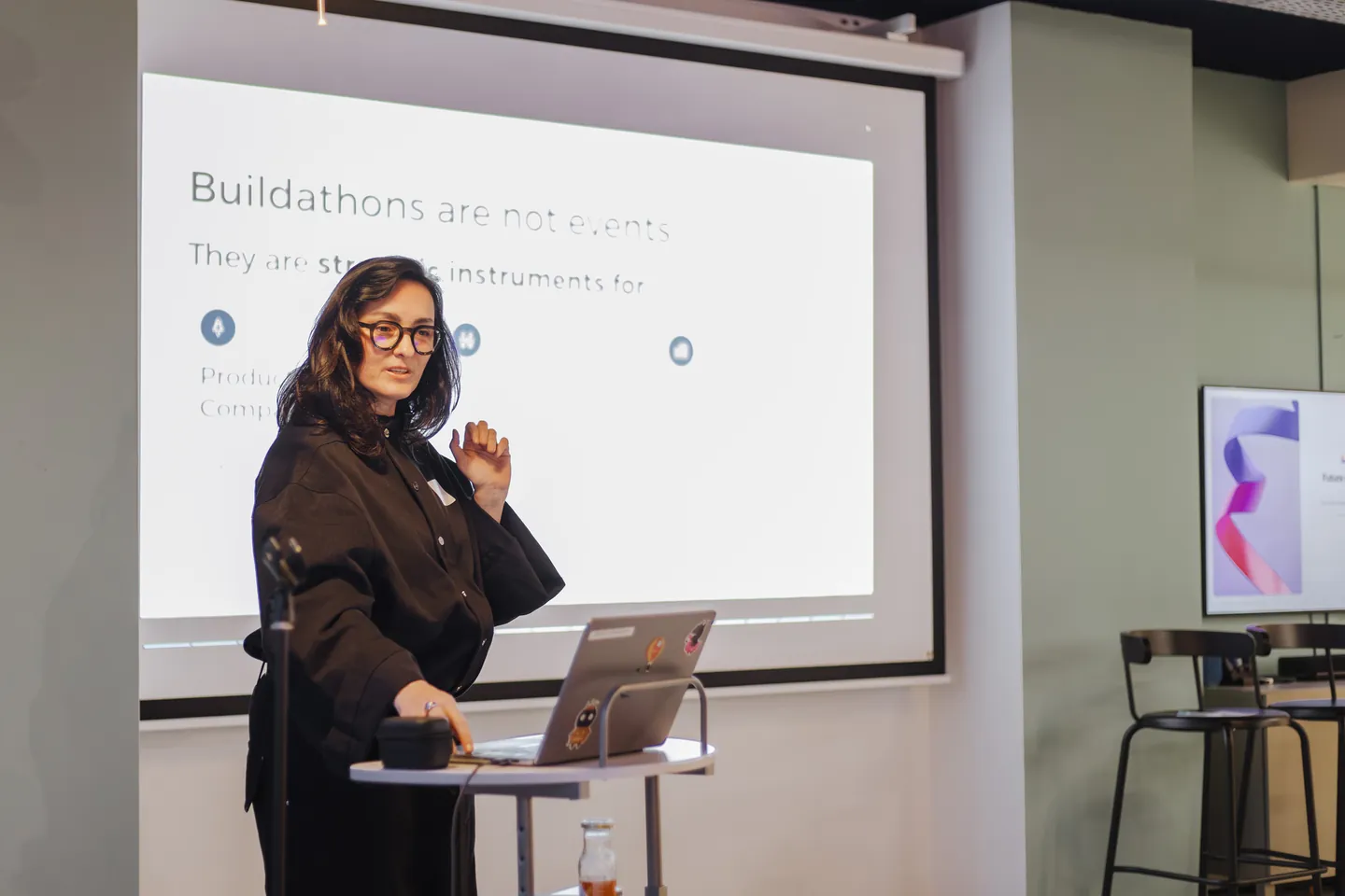 Dima Abramov presenting a buildathon strategy slide during the Amplitude and Lovable community event in Amsterdam.