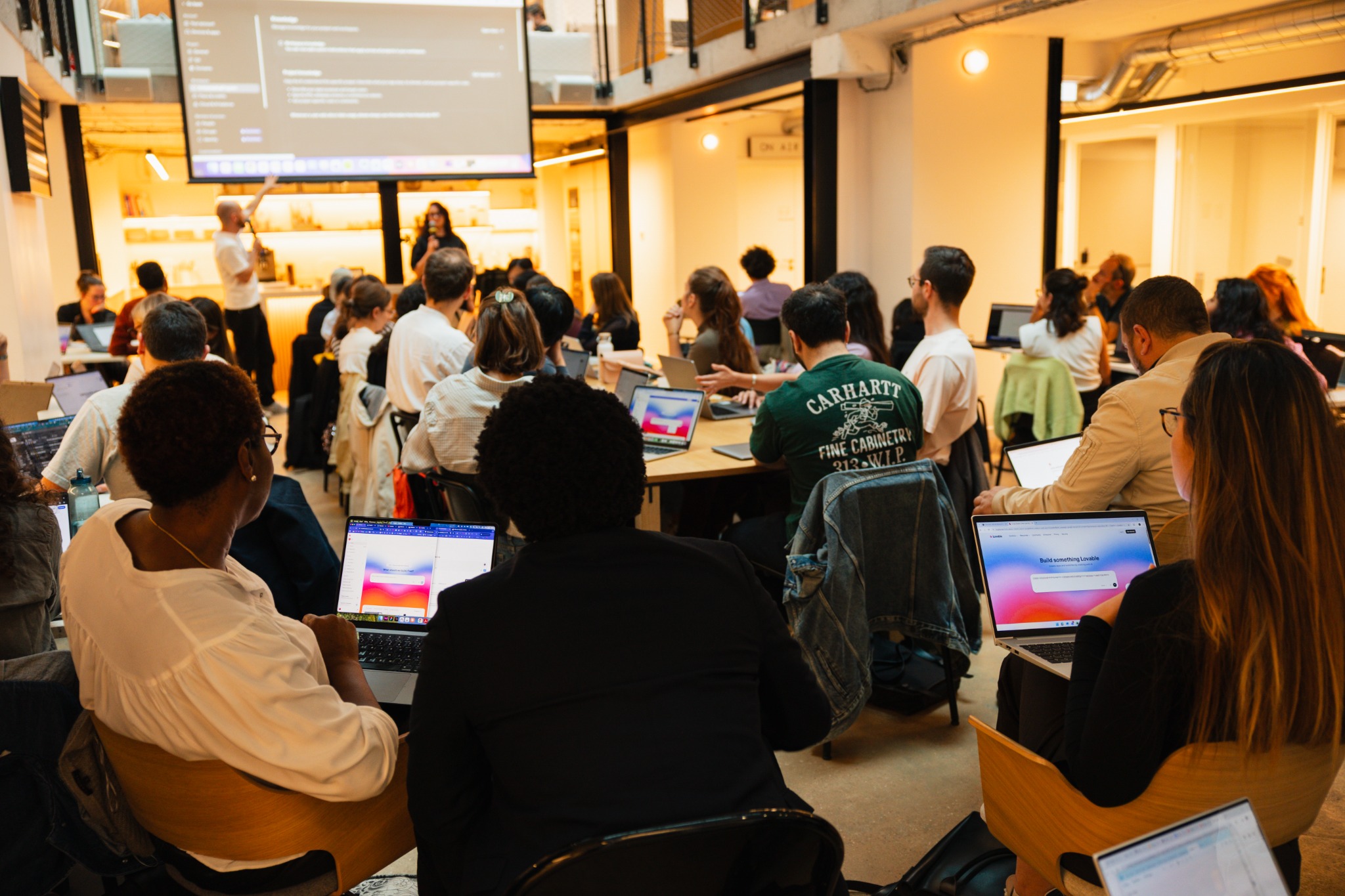 Participants watching a live building demonstration during the workshop in Paris.