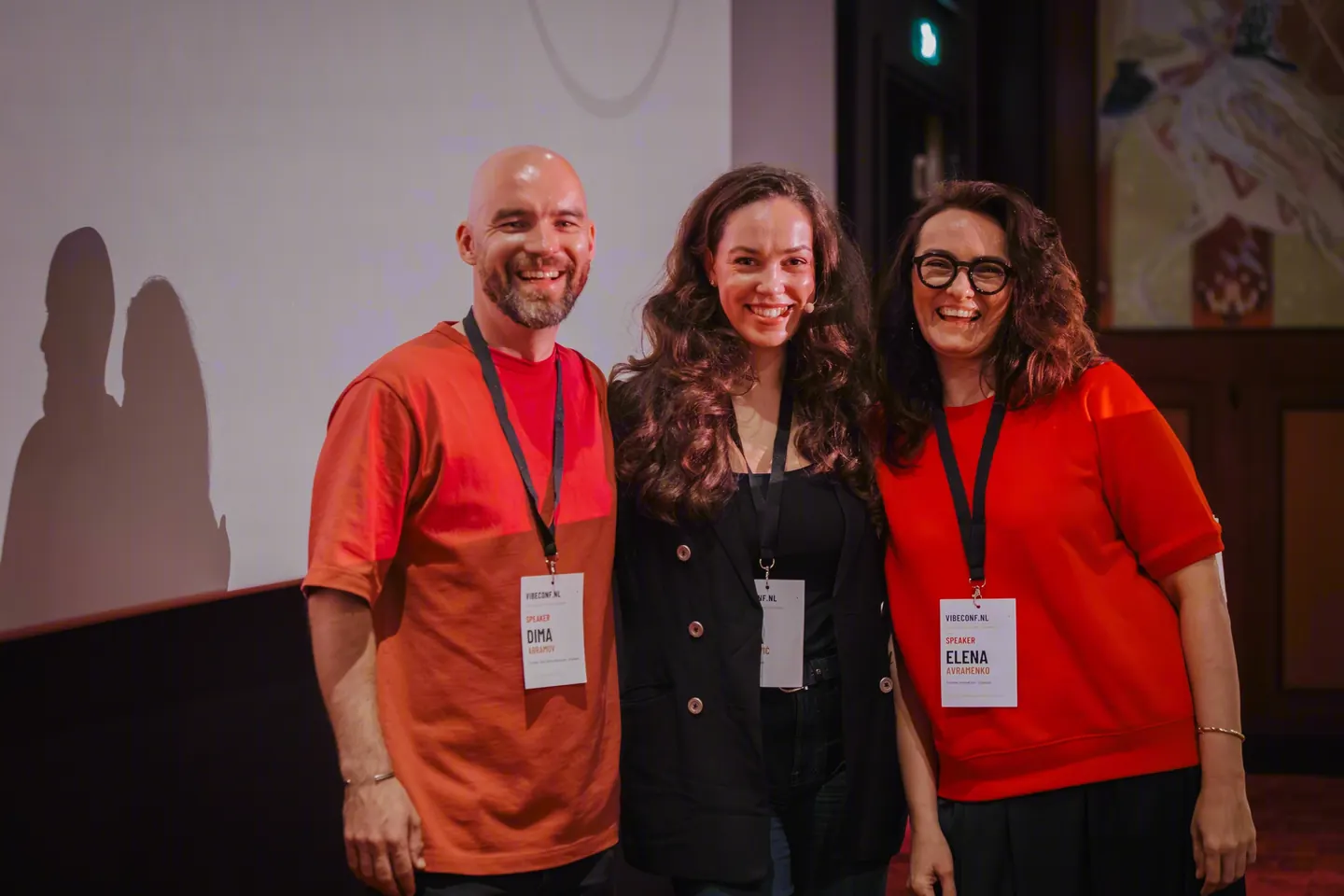 Dmitrii Abramov, the host Mila Jovićević and Elena Avramenko on stage.