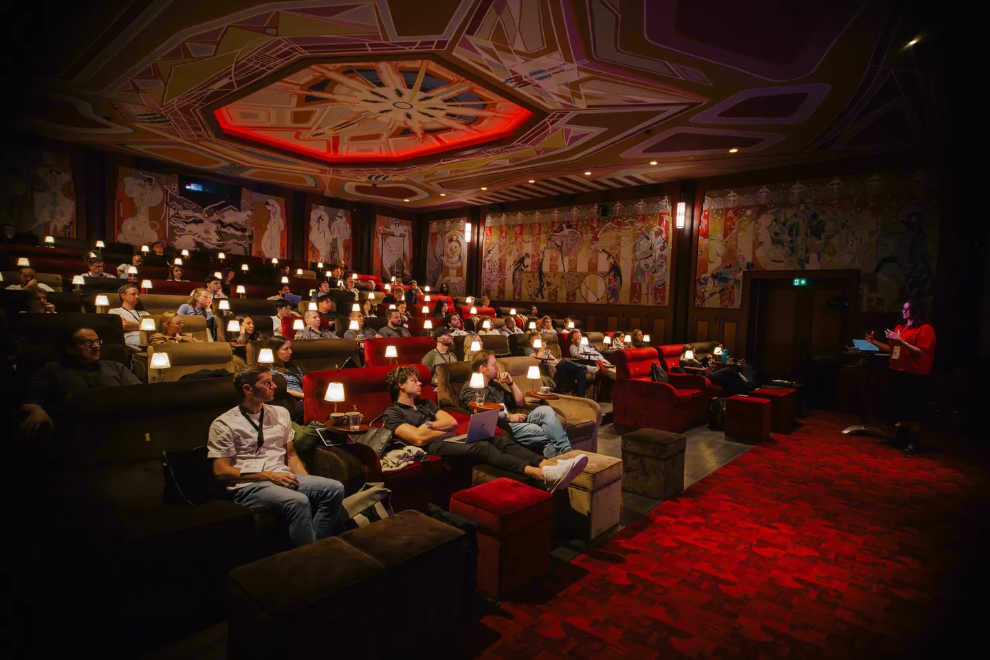 The audience in the red armchairs of the Pathé Tuschinski hall, a small lamp lit at every seat.